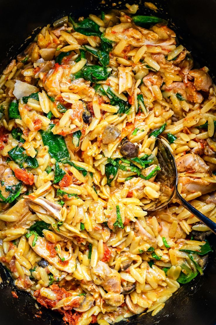 a skillet filled with pasta and vegetables