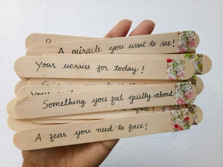 four wooden bookmarks with writing on them