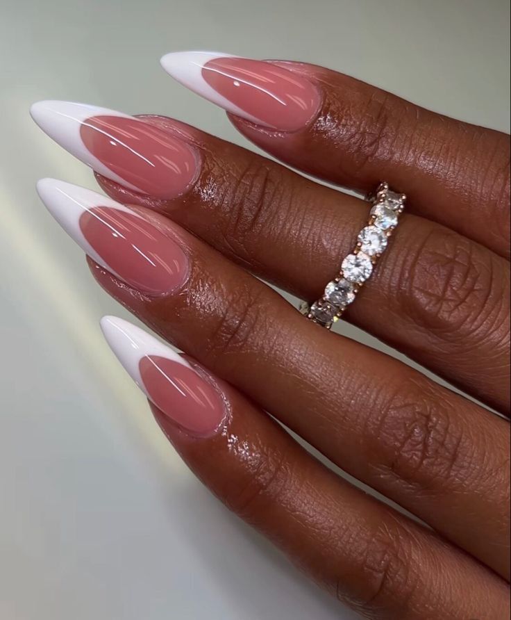 a woman's hand with pink and white acrylic nails