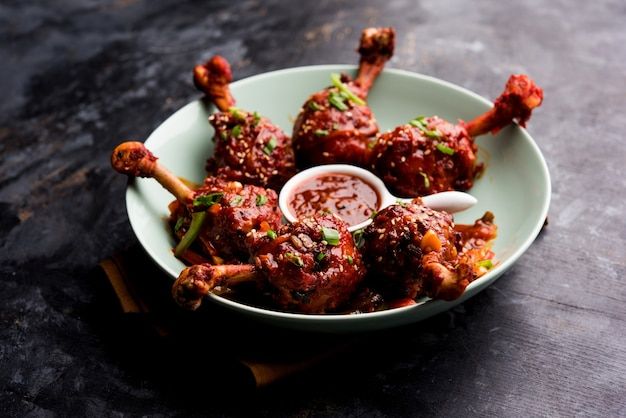 a white plate topped with meat covered in sauce and skewered on toothpicks