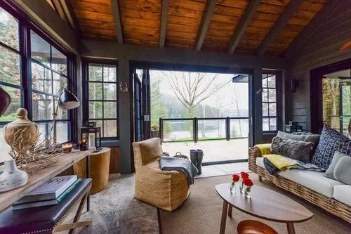 a living room filled with furniture and lots of windows