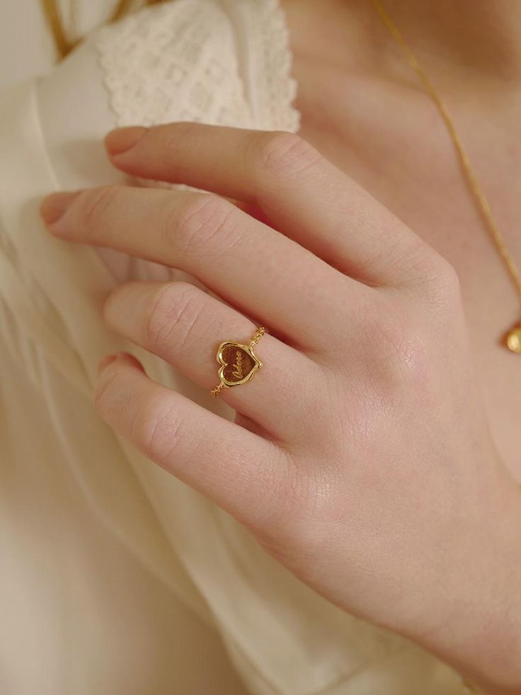 a woman's hand with a gold ring on it