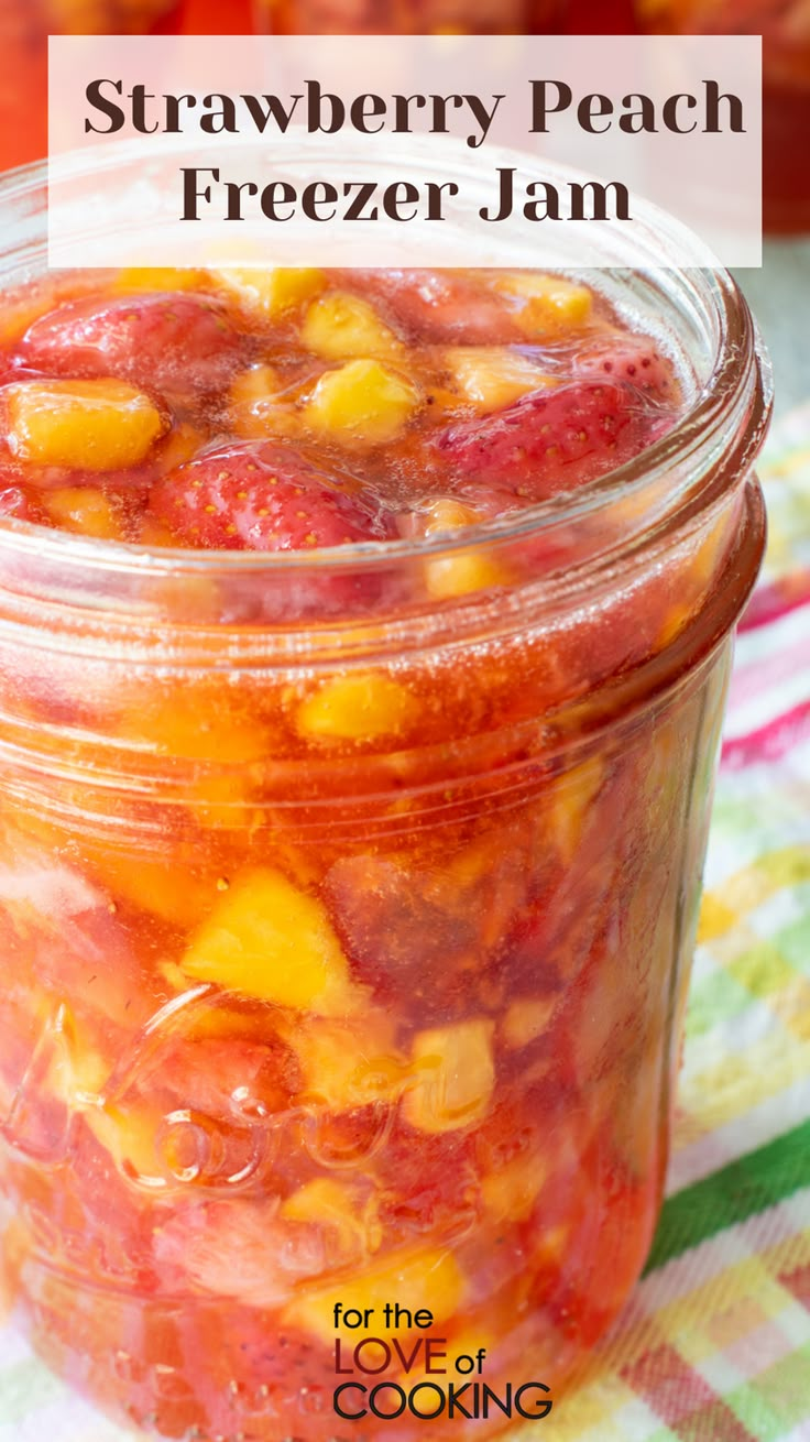 strawberry peach freezer jam in a glass jar with text overlay that reads, strawberry peach freezer jam for the love of cooking