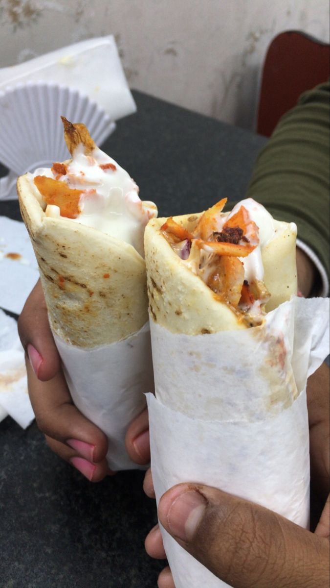 two burritos sitting on top of a table