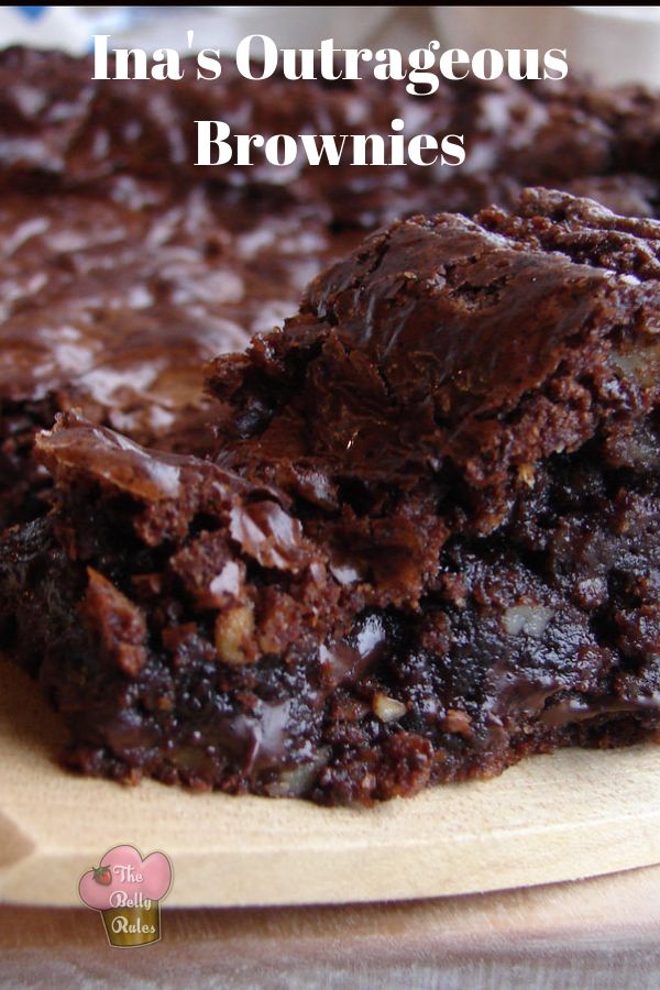 a close up of a plate of brownies with chocolate frosting on it and the words, i'm mrs outraggus brownies