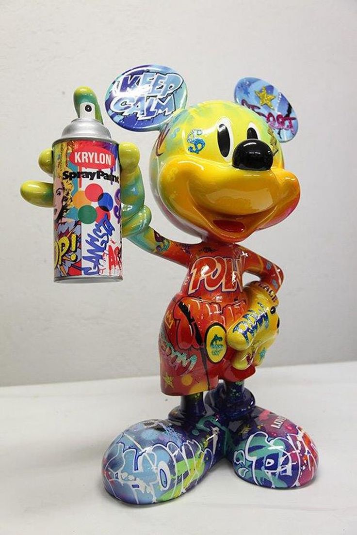 a mickey mouse figurine holding a candy bar in one hand and an empty bottle in the other