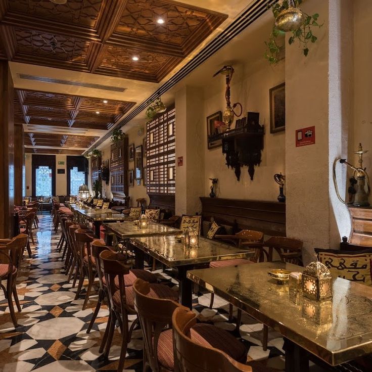 a restaurant with tables and chairs lined up against the wall