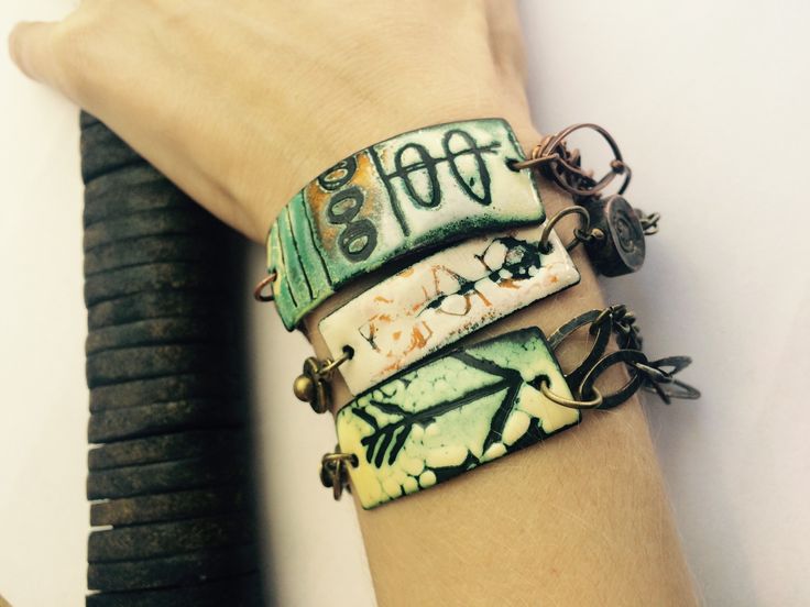 a woman's arm with three different bracelets on it