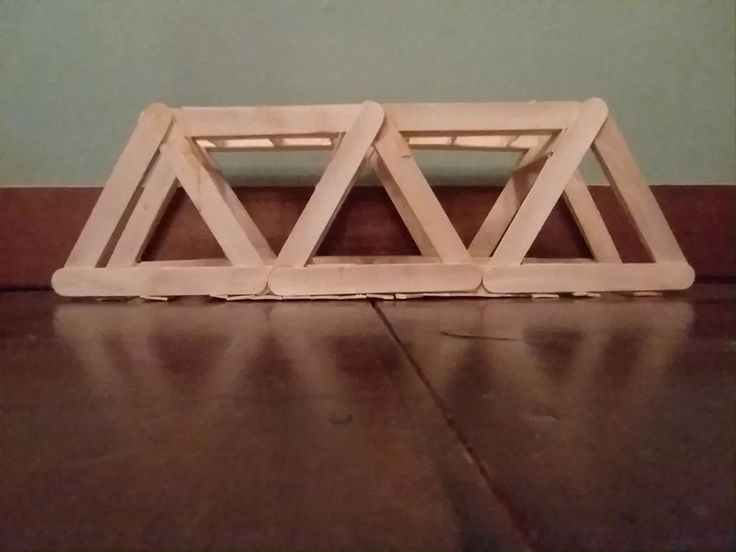 two wooden frames sitting on the floor next to each other