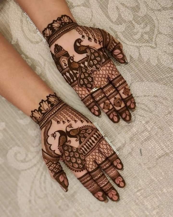 two hands with henna designs on them