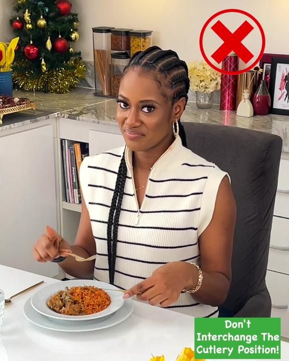 a woman sitting at a desk with a plate of food in front of her and the caption don't interchange the cutlery position