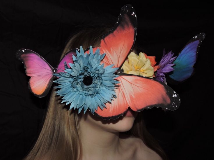 a woman with butterfly wings and flowers in her hair