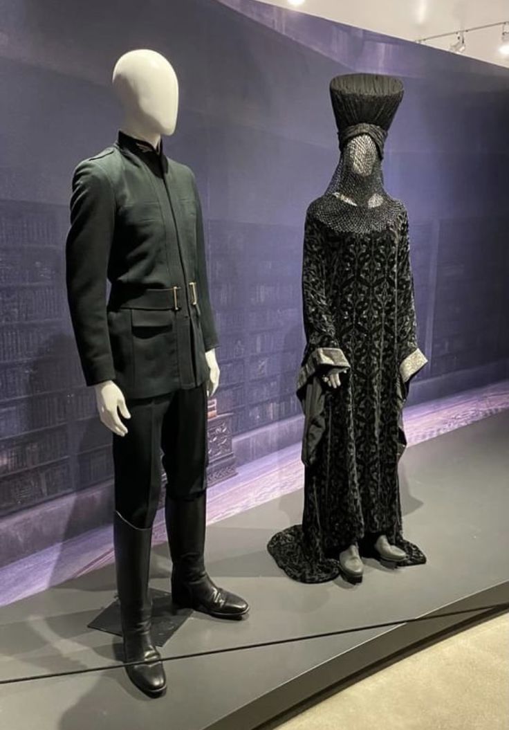 two mannequins dressed in black and white clothing stand next to each other