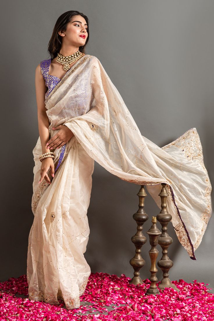 White and gold saree highlighted by zardozi embroidered abstract motifs with placed peacock motifs. Comes with blouse.
Components: 2
Pattern: Embroidered
Type Of Work: Zardozi, Sequin 
Neckline: V-neck
Sleeve Type: Sleeveless
Fabric: Tissue
Color: White,Gold
Other Details: 
Contrast saree piping
Closure: Blouse: Back placket
Occasion: Sangeet,Wedding - Aza Fashions Festive Bollywood Pre-draped Tussar Silk Saree, Eid Chanderi Pre-draped Saree With Cutdana, Designer Art Silk Pre-draped Saree With Zari Work, Gold Tussar Silk Pre-draped Saree For Reception, Bollywood Style Art Silk Pre-draped Saree With Sheer Dupatta, Festive Bollywood Pre-draped Saree In Chanderi, Festive Chanderi Pre-draped Saree With Zari Work, Dola Silk Pre-draped Saree With Sheer Dupatta For Diwali, Festive Pre-draped Tissue Silk Saree