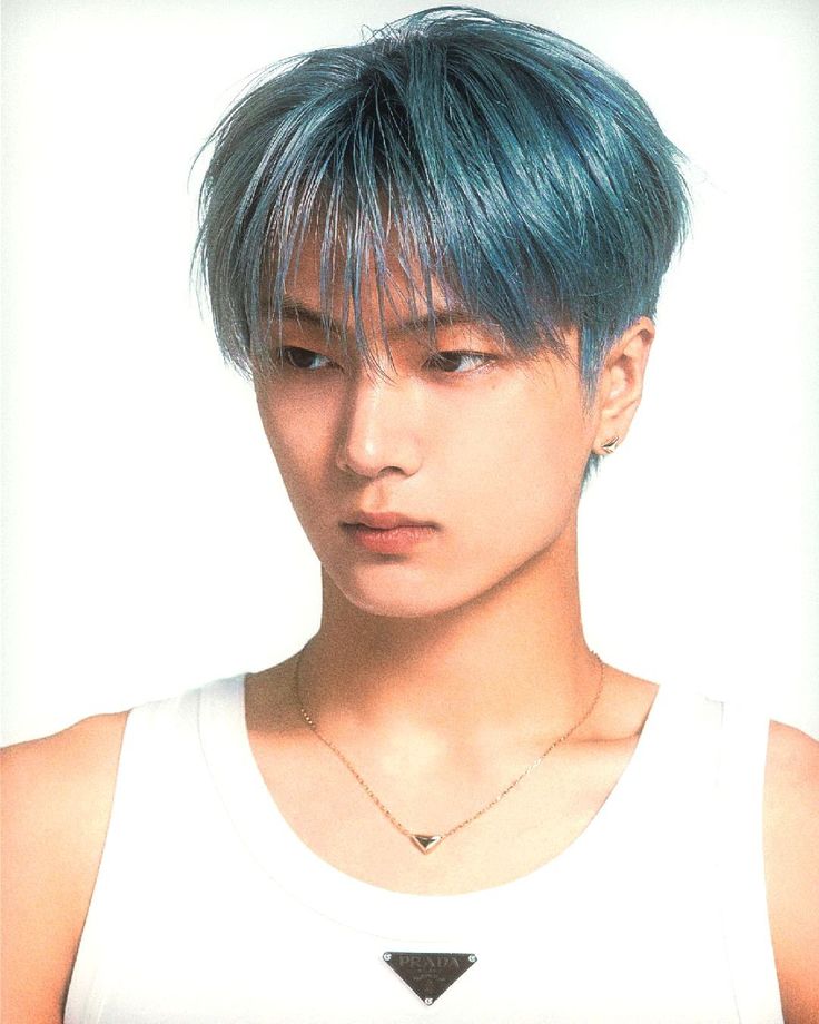 a young man with blue hair wearing a white tank top