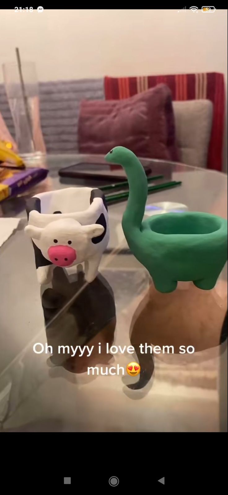 two toy animals sitting on top of a glass table