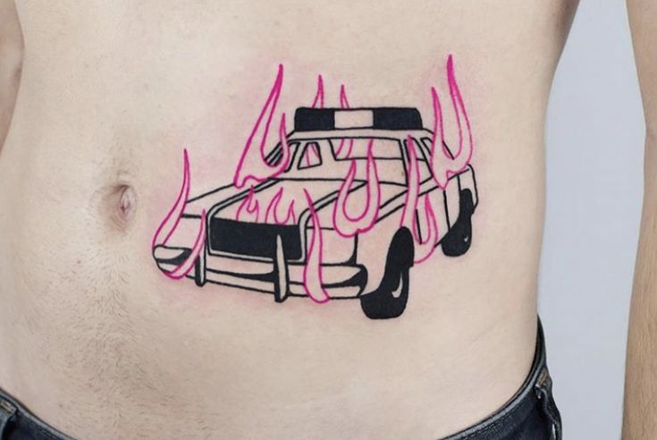 a man's stomach with a drawing of a car on the side and flames coming out of it