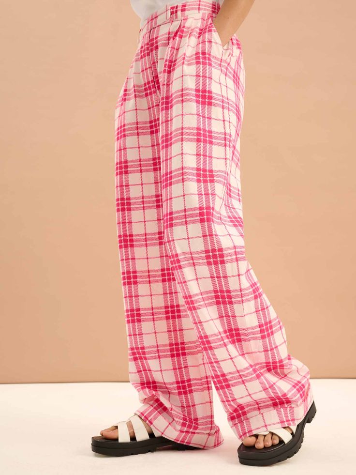 Candy is a trouser designed for dress-up, dress-down styling in a playful pink check print. Crafted in BCI member cotton the pleated details draw inspiration from classic tailoring. Pair with a crisp shirt for an office-ready look or matching Cindy waistcoat for a Clueless-inspired co-ord look. Relaxed Fit Pink Pants For Workwear, Plaid Cotton Bottoms For Work, Plaid Cotton Workwear Bottoms, Trendy Pink Bottoms For Daywear, Fitted Pink Pants For Daywear, Tailored Pink Bottoms For Fall, Plaid Cotton Bottoms For Business Casual, Tailored Casual Pink Bottoms, Casual Tailored Pink Bottoms