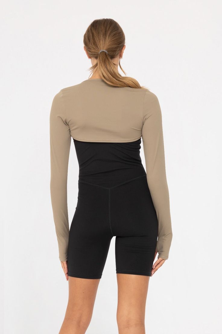 -Mini Long Sleeve Shrug- For all the Yoga and Pilates girlies out there, enhance your look with our stylish Mini shrug. With thumbholes for added comfort and a snug fit, it's made of soft fabric to keep you cool and cozy. Whether you're practicing yoga or Pilates, this shrug is the perfect blend of fashion and function. Keep your chest and shoulders protected from the sun while layering it over your favorite outfits. Winter Workout Tops With Thumbholes, Workout Tops With Thumbholes, Fitted Cropped Activewear For Fall, Fitted Yoga Tops For Winter, Versatile Stretch Winter Shrug, Versatile Stretch Shrug For Winter, Winter Yoga Fitted Tops, Stretch Athleisure Crop Top For Fall, Fitted Spring Activewear With Thumbholes