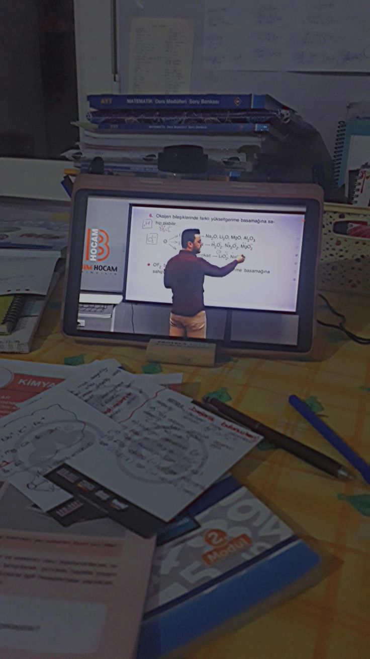 a table topped with lots of different types of papers and electronic devices on top of it