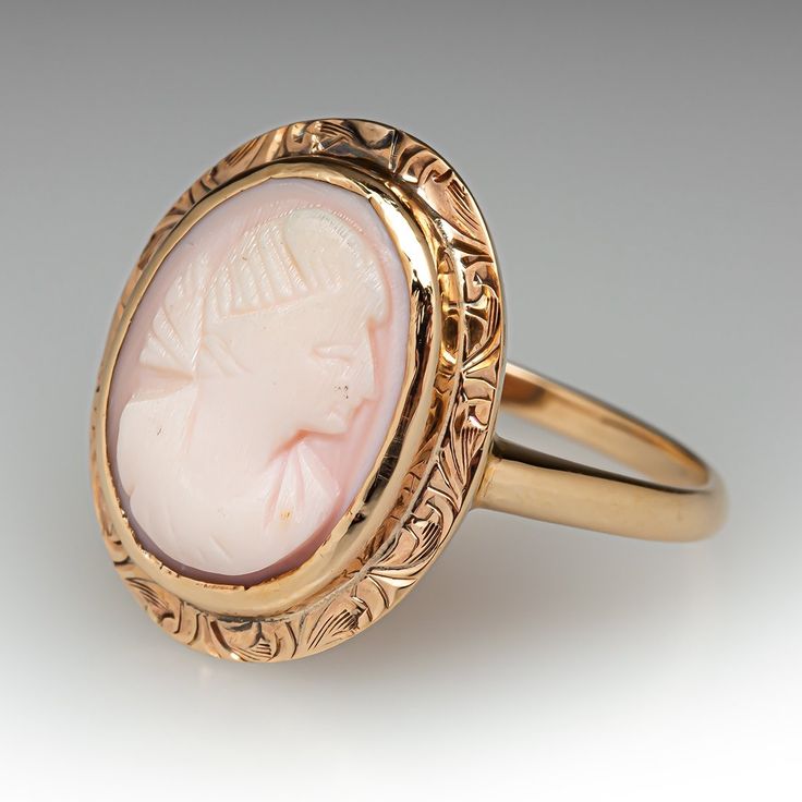 This elegant antique ring features a shell cameo and is crafted of 14k yellow gold. This ring is currently a size 9.75. The cameo shows heavy wear. Cameo 14k Gold Rings For Anniversary, 14k Gold Cameo Rings For Wedding, 14k Gold Cameo Rings For Anniversary, Wedding Cameo Ring In Yellow Gold, Vintage Cameo Engraved Ring For Formal Occasions, Wedding Yellow Gold Cameo Ring, Victorian Style Cameo Signet Ring For Formal Occasions, Elegant Oval Cameo Engraved Ring, Vintage Formal Cameo Engraved Ring