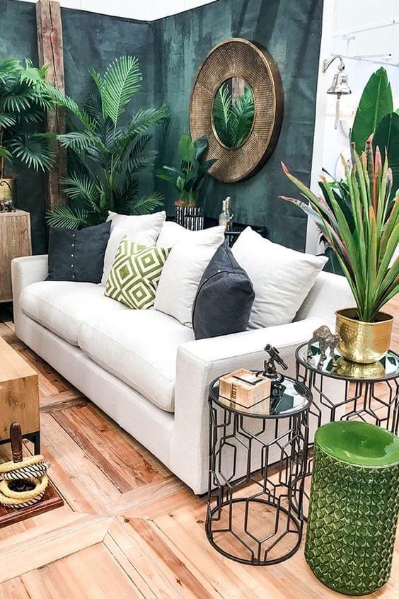 a living room filled with lots of furniture and plants