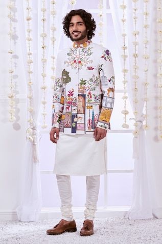 White full sleeves bandhgala crafted in 100% silk with Moroccan Kalamkari embroidery. Paired with a solid white kurta and a churidar. - Aza Fashions Wedding Bandhgala With Printed Motifs, Wedding Bandhgala With Printed Motifs For Diwali, Designer White Nehru Jacket, Festive Bandhgala With Printed Motifs And Long Sleeves, White Sherwani With Printed Motifs For Festivals, Designer White Sherwani With Printed Motifs, Ceremonial White Nehru Jacket With Long Sleeves, Long Sleeve Bandhgala With Printed Motifs For Eid, Wedding Sherwani With Printed Motifs In White