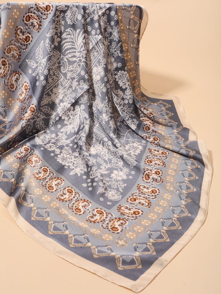 a blue and white scarf laying on top of a table