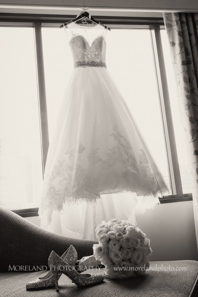 a wedding dress and shoes are sitting on a window sill