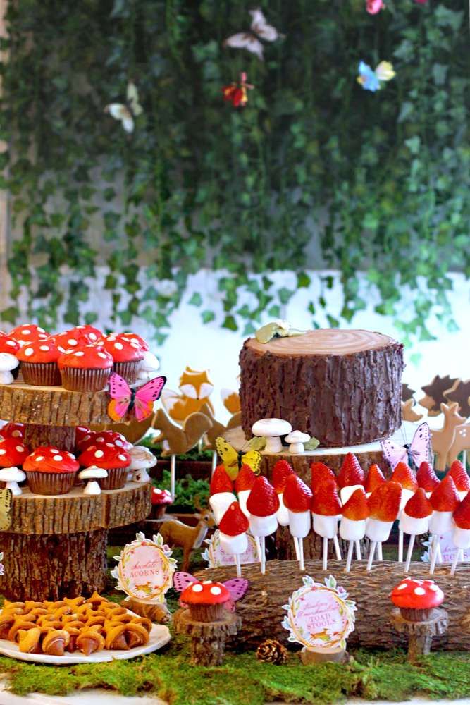 a table topped with lots of cakes and cupcakes