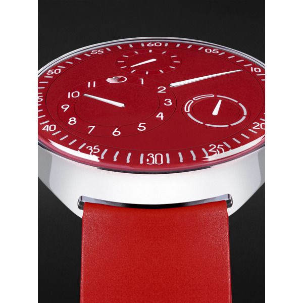 Ressence has a ""less is more"" philosophy but it can still make a statement, as this limited-edition 'Type 1 Slim' watch shows. Rendered almost entirely in red, it represents a departure from the house's signature colour palette, inspired by a one-of-a-kind timepiece created in 2020. Like other iterations of the model, this one has a titanium case and runs on an Orbital Convex System that's driven by the minute axle of an automatic movement to display the time and day in a unique way. The rubb… Timeless Red Watch Accessories, Classic Red Analog Watch, Red Chronograph Analog Watch For Formal Occasions, Red Analog Chronograph Watch For Formal Occasions, Red Watches With Subdials And Round Dial, Red Automatic Watches With Round Dial, Classic Red Chronograph Watch With Round Dial, Red Automatic Watch With Round Dial, Red Watch With Subdials