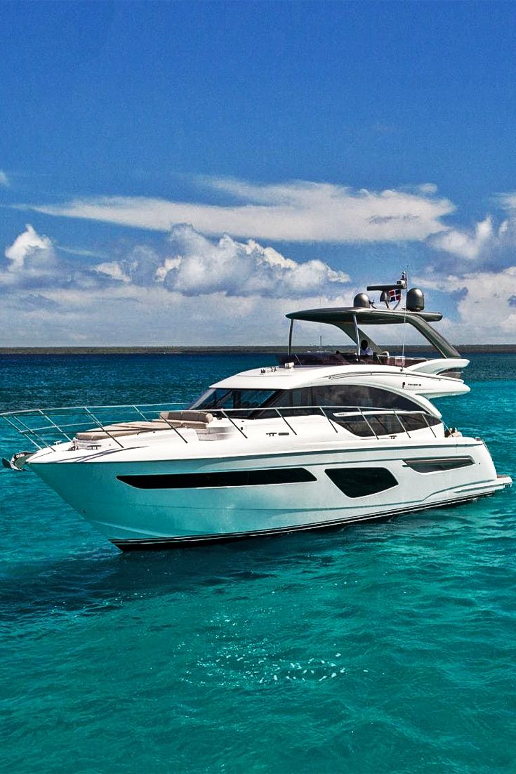 a white boat floating in the ocean next to another boat