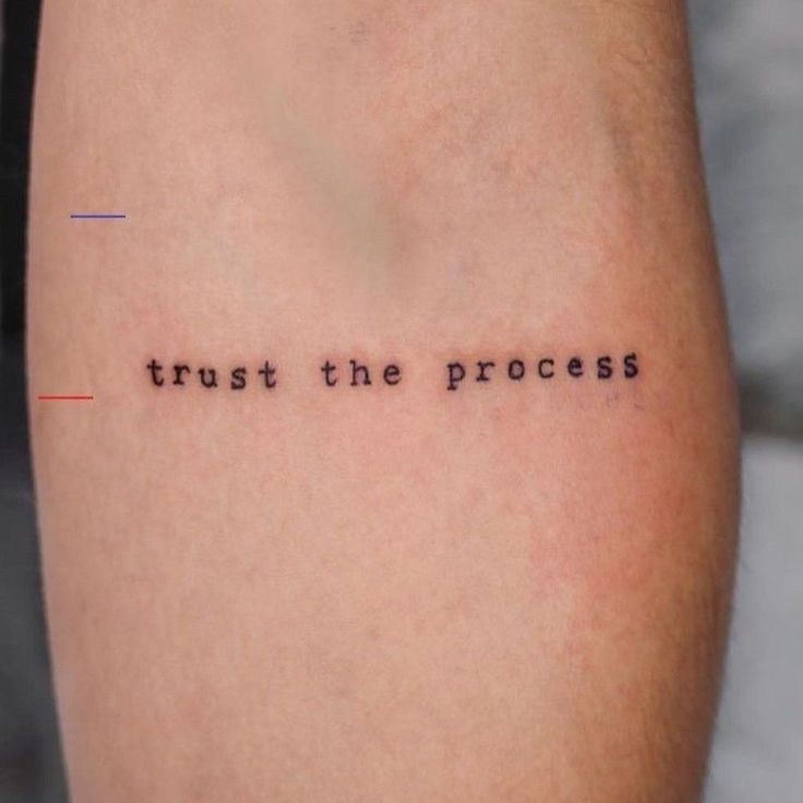 a tattoo saying trust the process on someone's leg