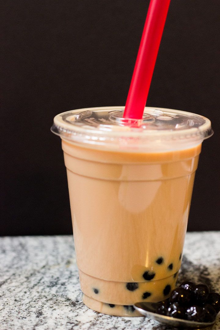 bubble tea in a plastic cup with a red straw