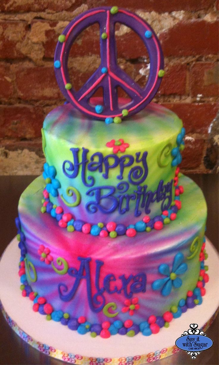 a multi - colored cake with peace sign on top