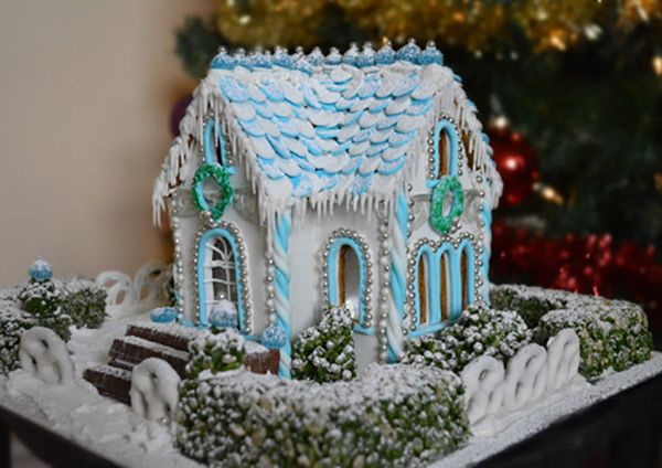 a gingerbread house decorated with icing and decorations