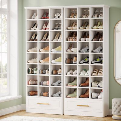 a white shoe rack filled with lots of shoes