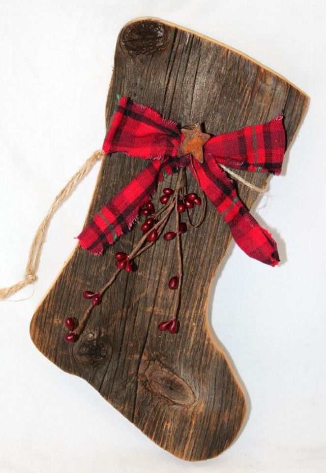 an image of a christmas stocking made out of wood with red and white plaid ribbon