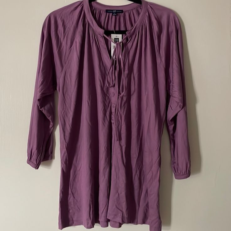 3/4 Sleeve Gap Blouse Brand New With Tag. Beautiful Purple Color With A Little Tie Up At The Neck. Gap Tops For Spring, Fall Beach Blouse With 3/4 Sleeves, Casual 3/4 Sleeve Beach Blouse, Spring Purple Half-sleeve Blouse, Casual 3/4 Sleeve Beach Tops, Spring Purple Half Sleeve Blouse, 3/4 Sleeve Shirt For Spring Day Out, Spring Casual Tunic With 3/4 Sleeves, Casual Spring Tunic With 3/4 Sleeves