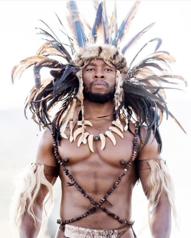 a man with long hair and feathers on his head