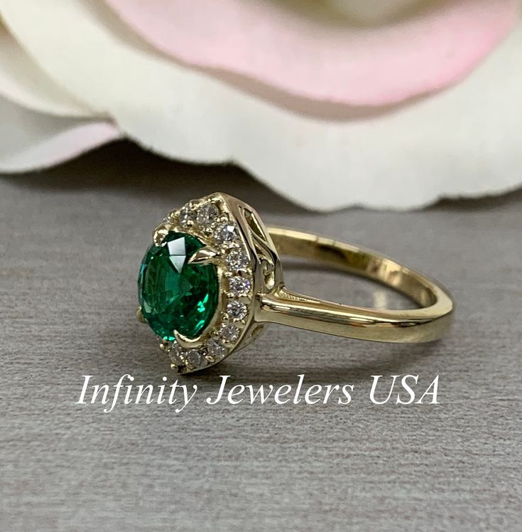 "The ring pictured is lab created emerald and moissanite #6410 We feature the finest quality lab grown emeralds in the world. The properties of lab-grown are physically, chemically and visually identical to natural, just grown in a lab setting. Emerald is the birthstone of May -Approximate total carat weight: 1.46 ctw diamond equivalent -Center Stone Size: approx. 1.20ct diamond equivalent -Center Stone Shape: round - extra brilliant 7mm -Gem Type: lab created emerald -Stone Clarity: VS2 -Stone Classic Halo Jewelry For May Birthstone, Formal Green Halo Jewelry, Heirloom Gia Certified Jewelry For May Birthstone, Heirloom Gia-certified Jewelry For May Birthstone, Anniversary Emerald Ring With Halo Design In Cubic Zirconia, Gia Certified Emerald Anniversary Ring, Classic Green Moissanite Jewelry, Gia Certified Cubic Zirconia Round Emerald Ring, Emerald Jewelry With Marquise Cut Center Stone