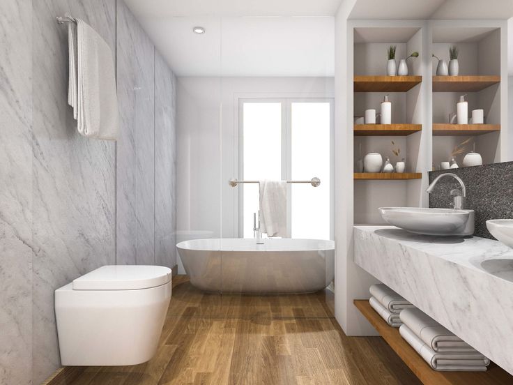 a bathroom with marble walls and flooring next to a bathtub, toilet and sink