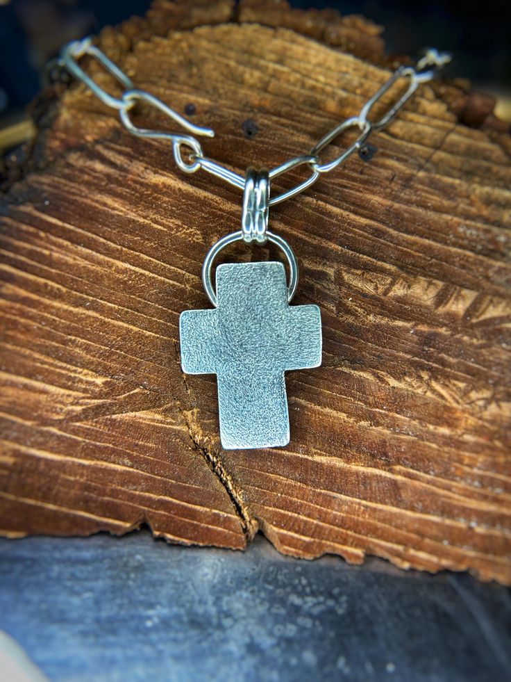 This hand crafted sterling silver cross necklace is 18 inches long on a handcrafted silver chunky chain. The cross is hand hammered just beautiful. Heirloom piece to last generations Silver Hammered Cross Necklace, Sterling Silver Necklace With Oxidized Cross Pendant, Sterling Silver Oxidized Crucifix Necklace, Oxidized Sterling Silver Cross Pendant Necklace, Silver Hand Forged Cross Pendant Jewelry, Hand Forged Silver Cross Pendant Necklace, Hand Forged Silver Cross Pendant Jewelry, Sterling Silver Cross Pendant Jewelry, Hand Forged Silver Cross Necklace