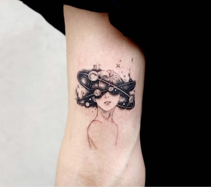 a woman's foot with a black and white tattoo design on her left ankle