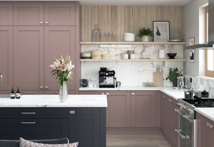 a kitchen with pink cabinets and marble counter tops