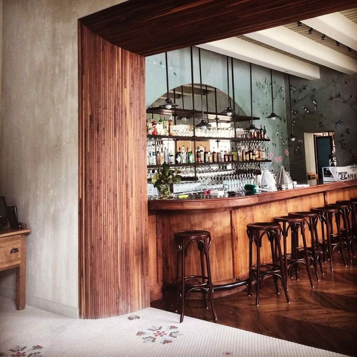 an empty bar with stools in front of it