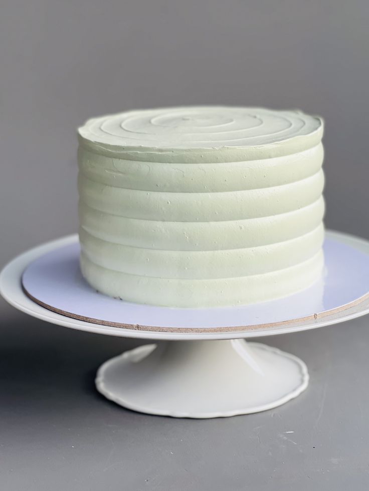 a white cake sitting on top of a plate