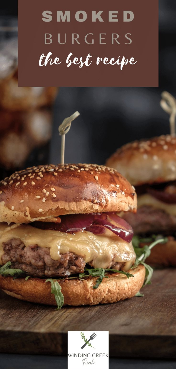 two hamburgers on a cutting board with text overlay that reads smoked burgers the best recipe