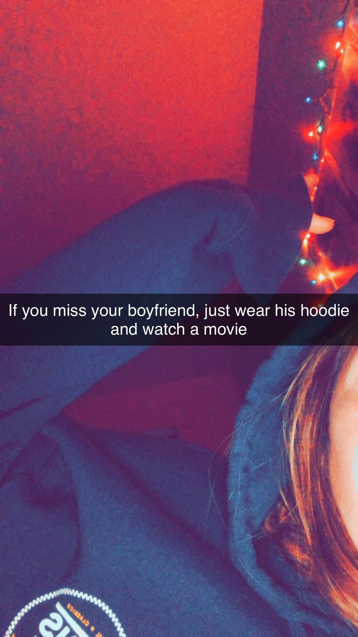 a woman laying in bed with her eyes closed and the caption if you miss your boyfriend, just wear his hoodie and watch a movie