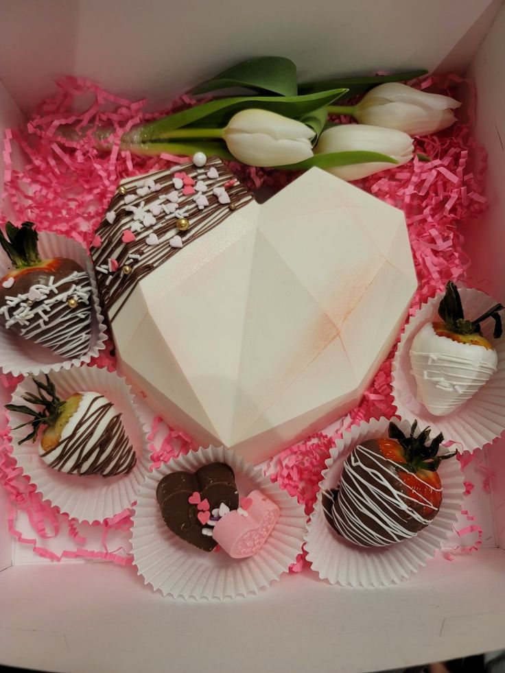 a box filled with chocolate covered strawberries and flowers